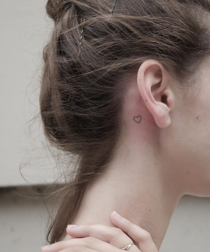 Subtle romance cute tiny outline heart tattoo behind the ear