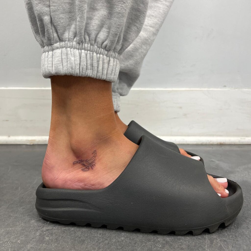 Subtle scorpion below the ankle fineline tattoo, a zodiac accent: Scorpio whispers