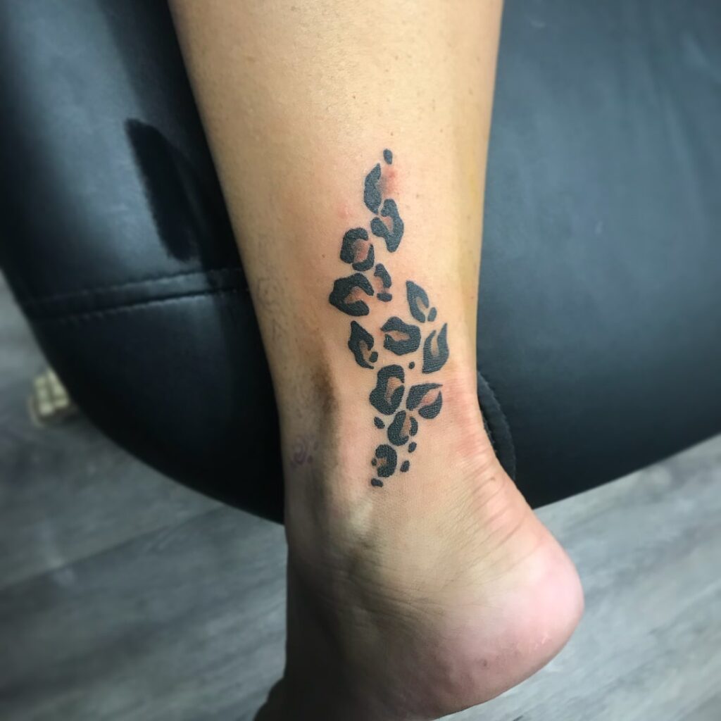 Subtle spots back of ankle leopard print tattoo for females