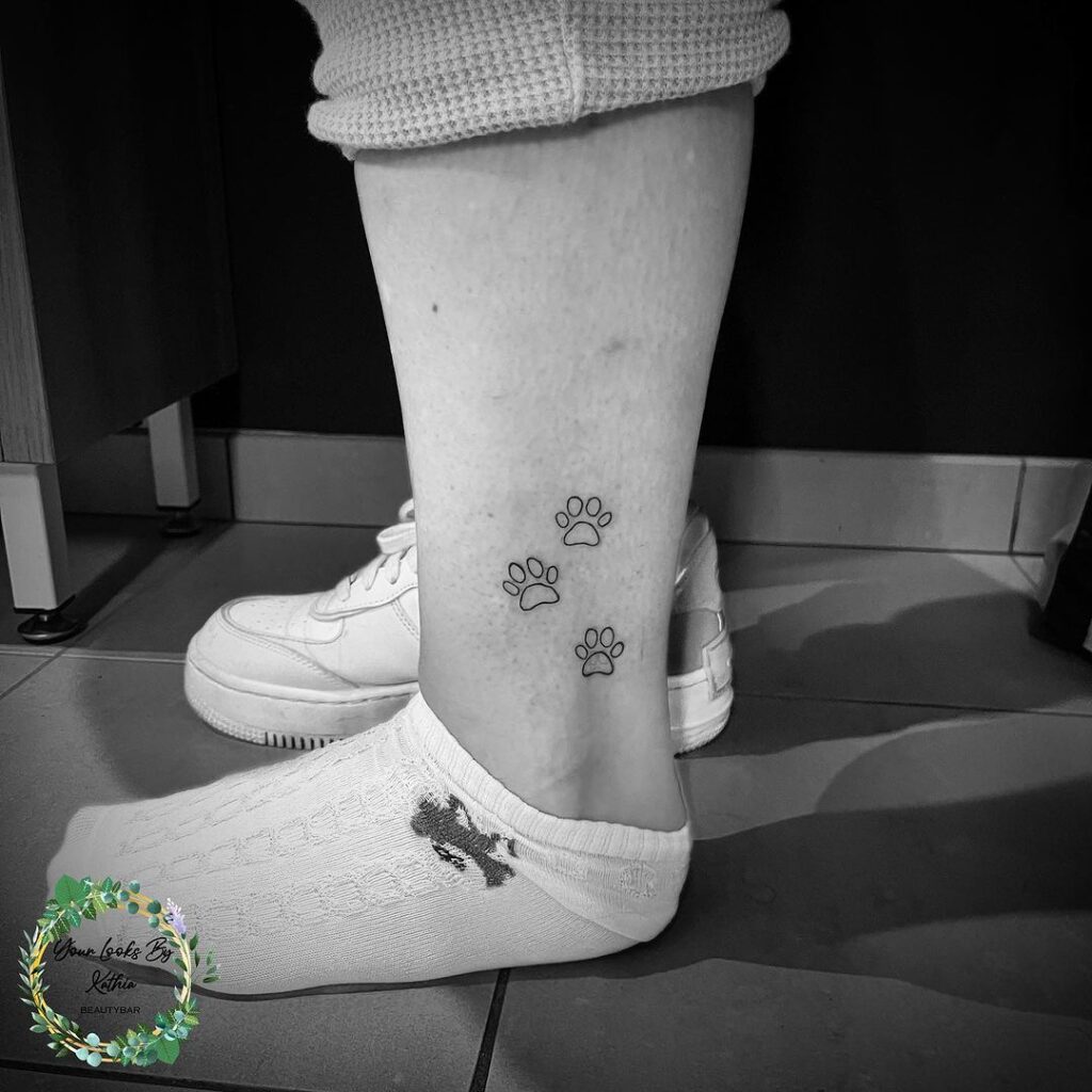 Subtle symmetry fineline paw prints trio above the ankle