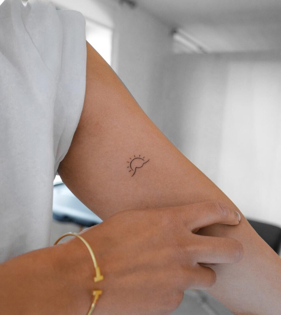 Sun and sea wave tattoo on the small inner arm bicep bliss
