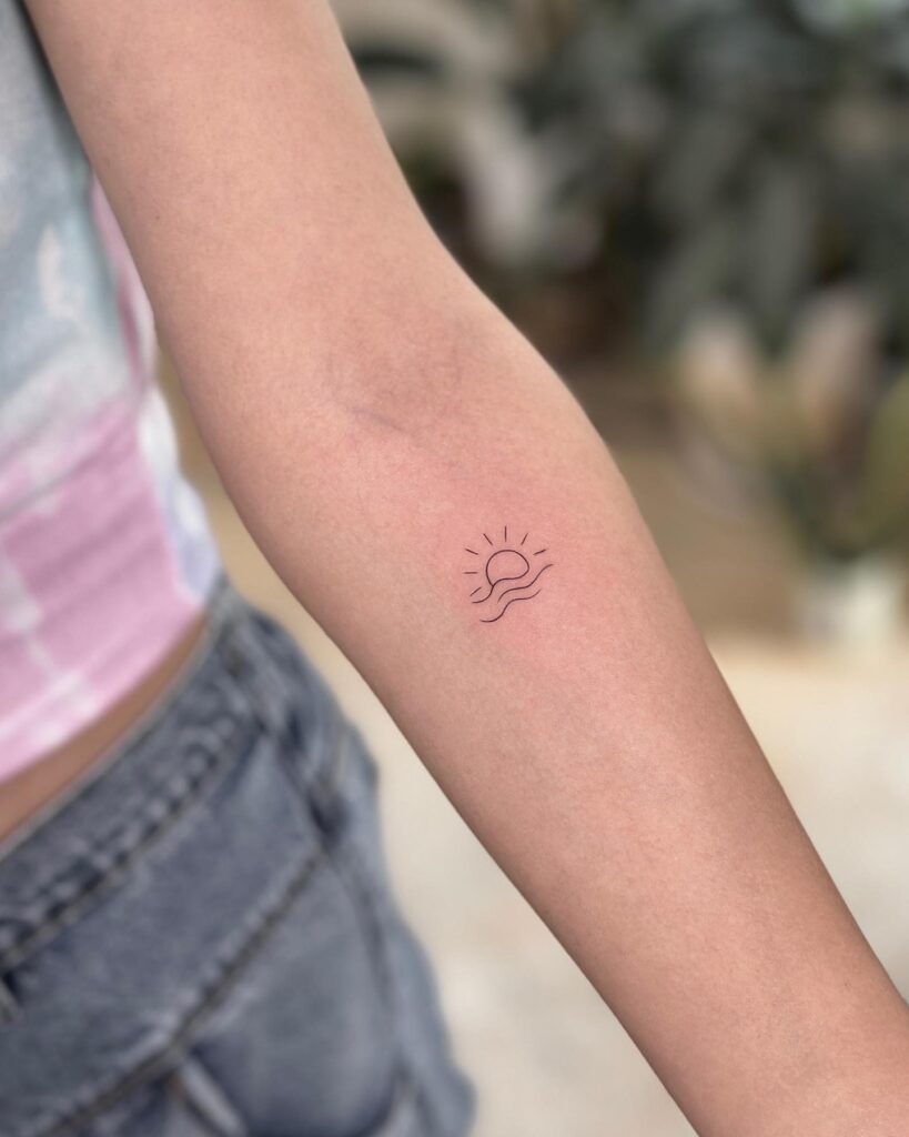 Sun and Wave Fineline Tattoo, a Coastal Beauty on Her Forearm: Serenity Shore