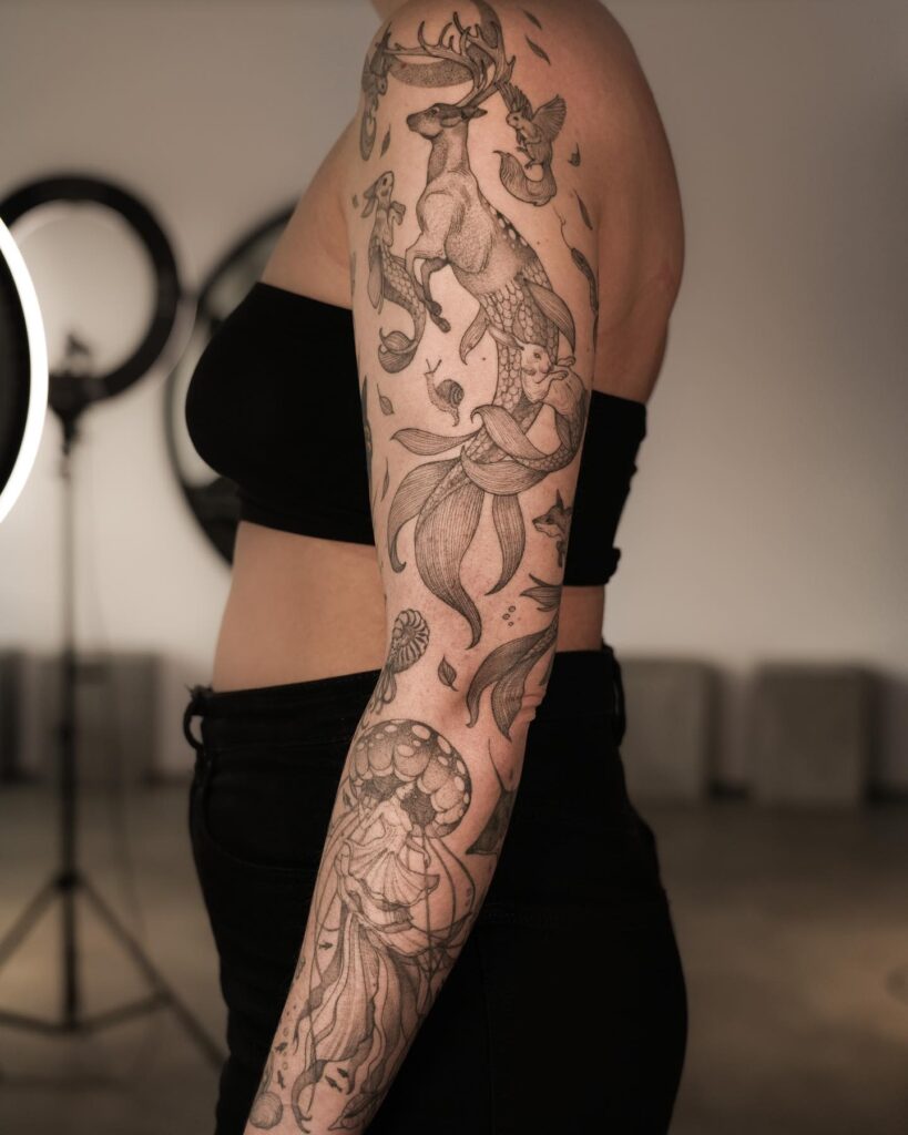 Surreal tattoo sleeve blending nature and mythical creatures in fine-line black and grey for women