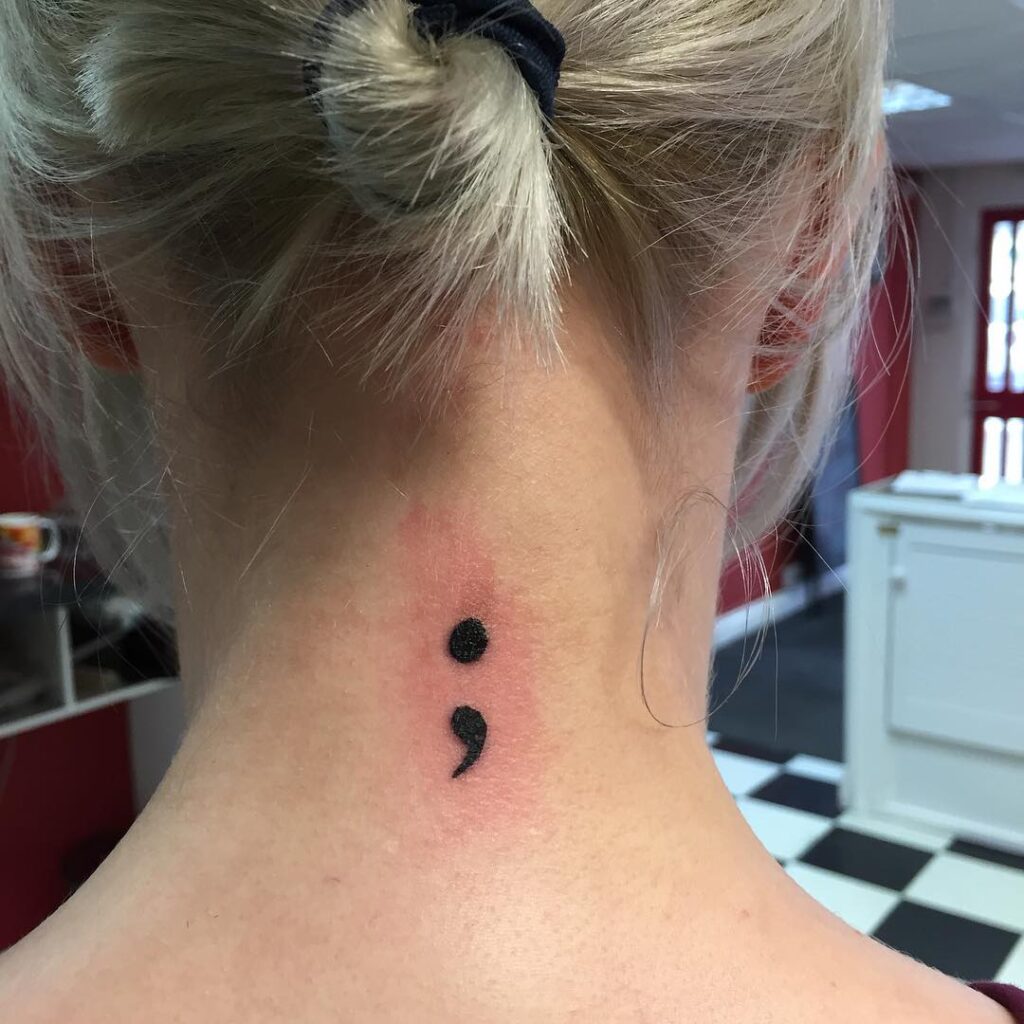 Symbol of resilience beautiful semicolon tattoo gracefully on a females neck