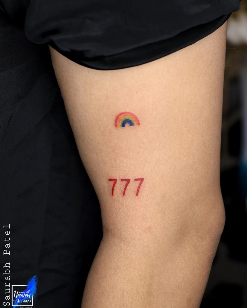Symbolic 777 Tattoo with a Touch of Color on the Bicep: Rainbow Connection 