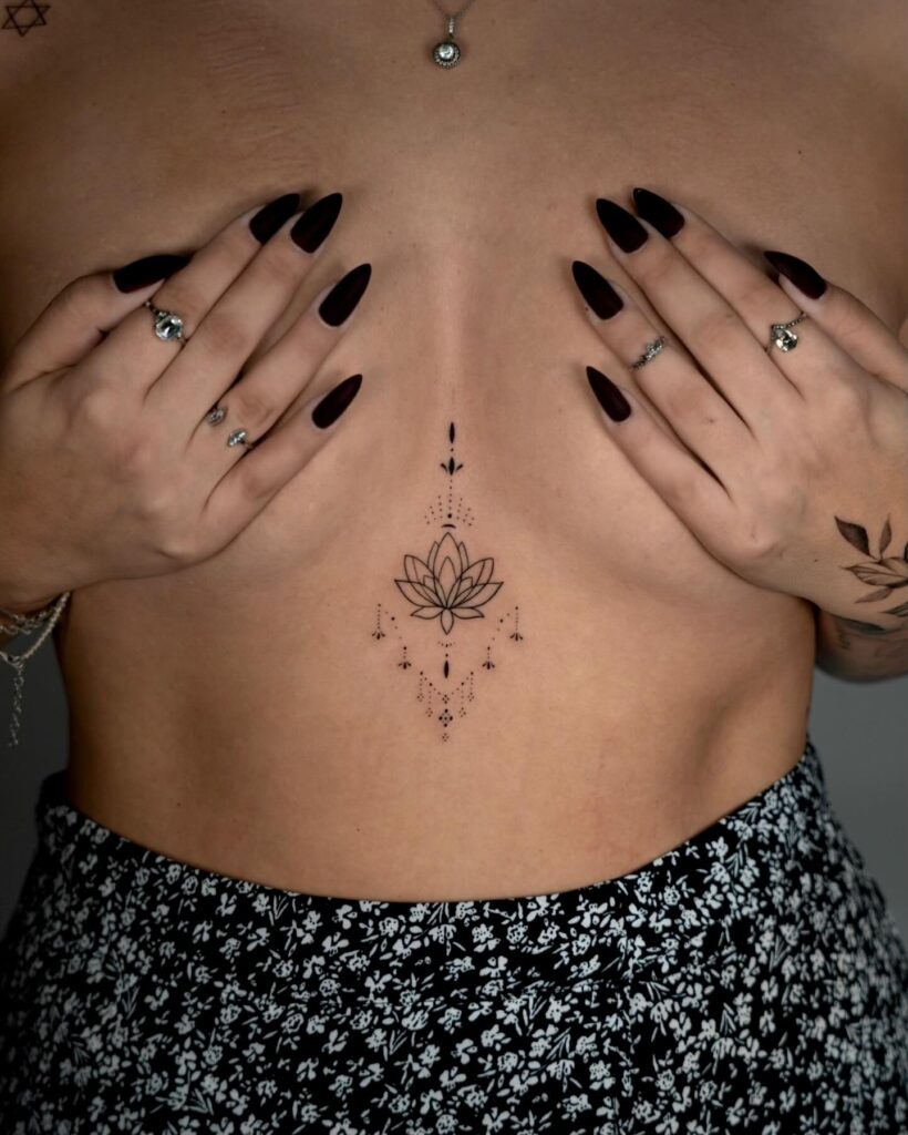 Symmetrical blooming lotus sternum tattoo representing personal growth