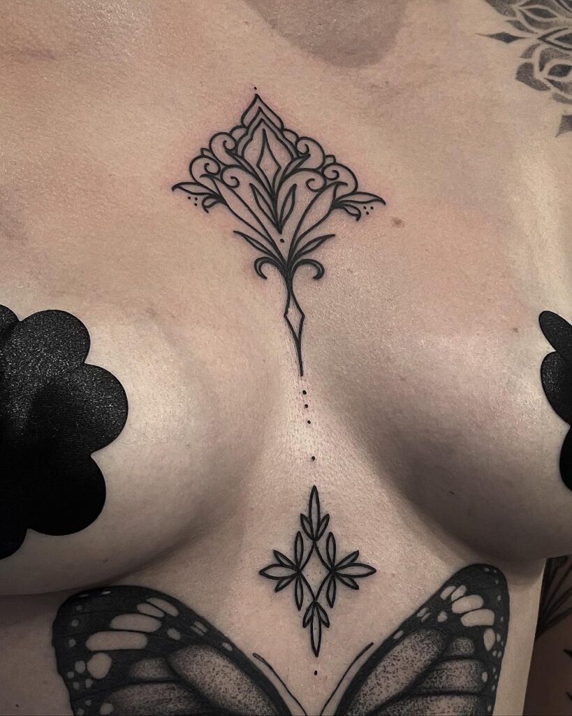 Symmetrical ornamental butterfly sternum tattoo ideas