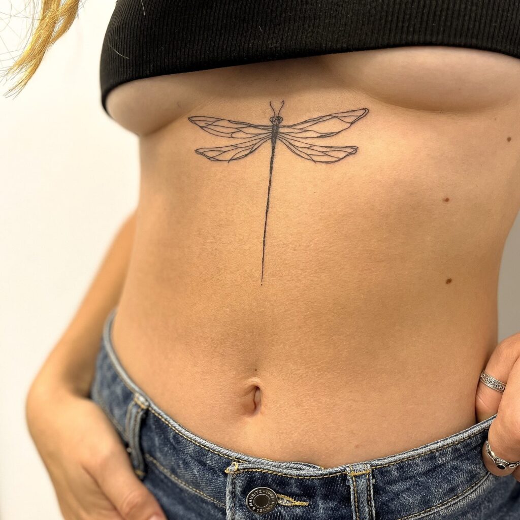 Symmetrical Sternum Dragonfly Tattoo for a Bold Yet Elegant Look