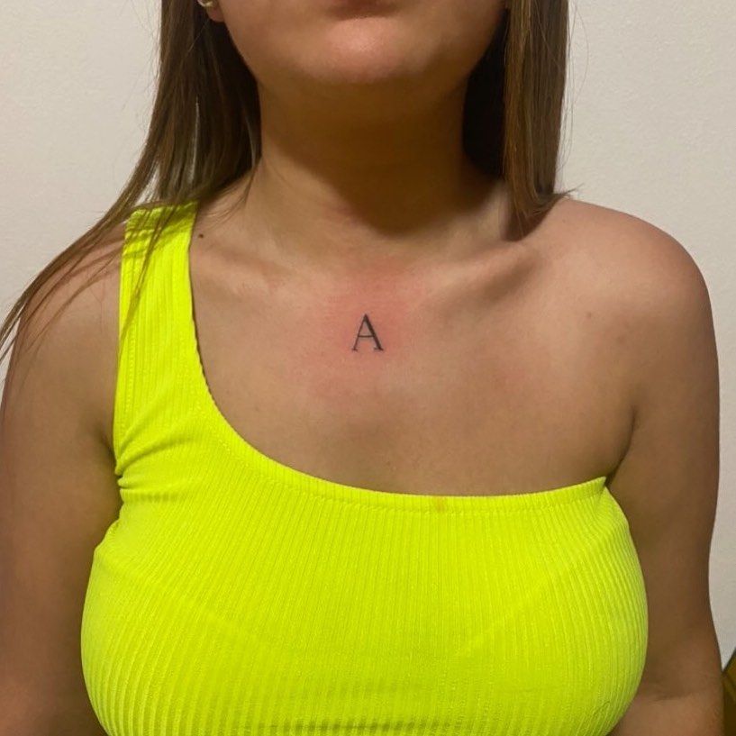 Tattoo on the Center of the Chest: Central Focus, Featuring Fineline Letter 'A'