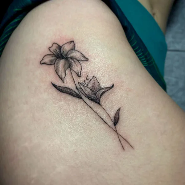 Thigh December birth flower tattoo