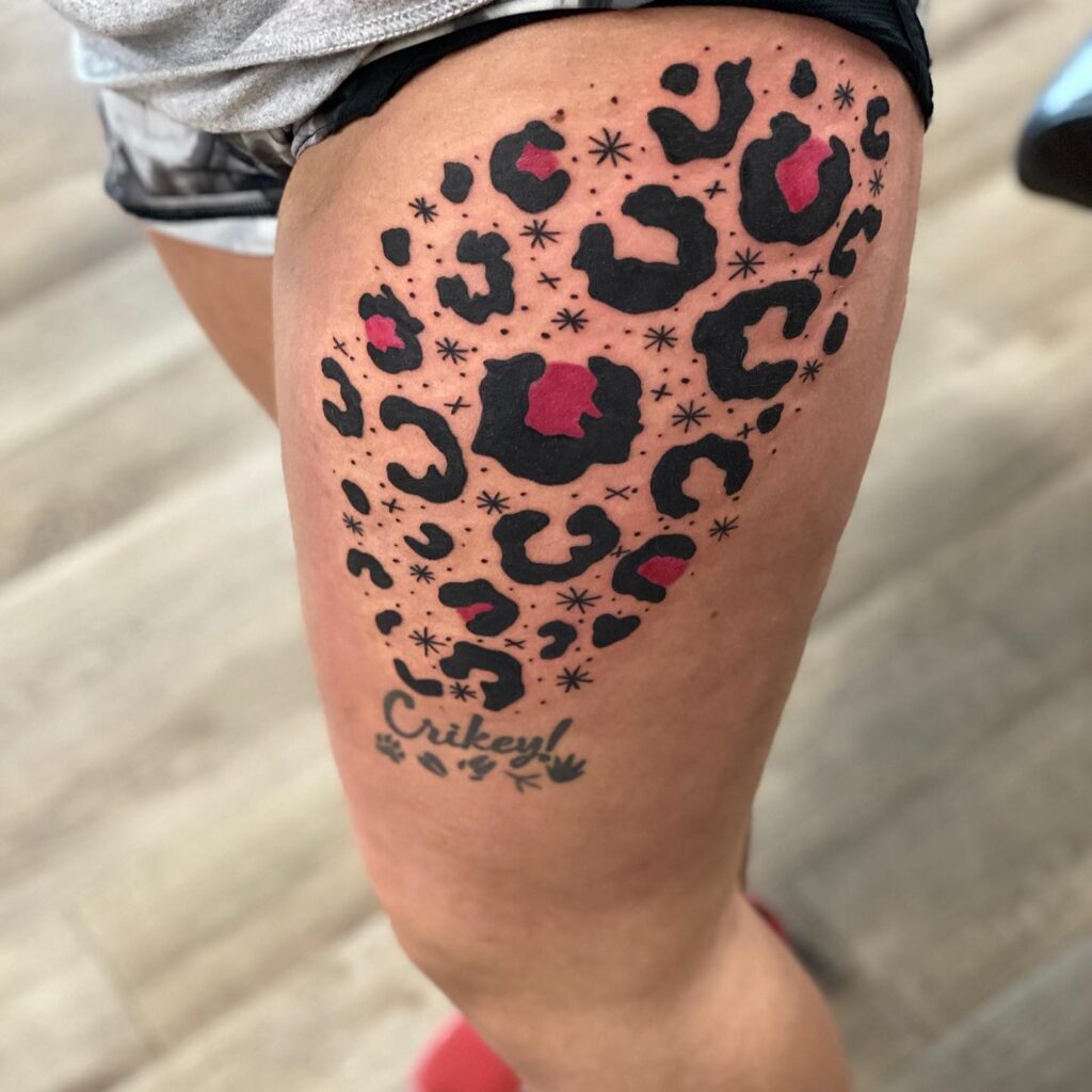 Thigh power move expressive leopard print tattoo