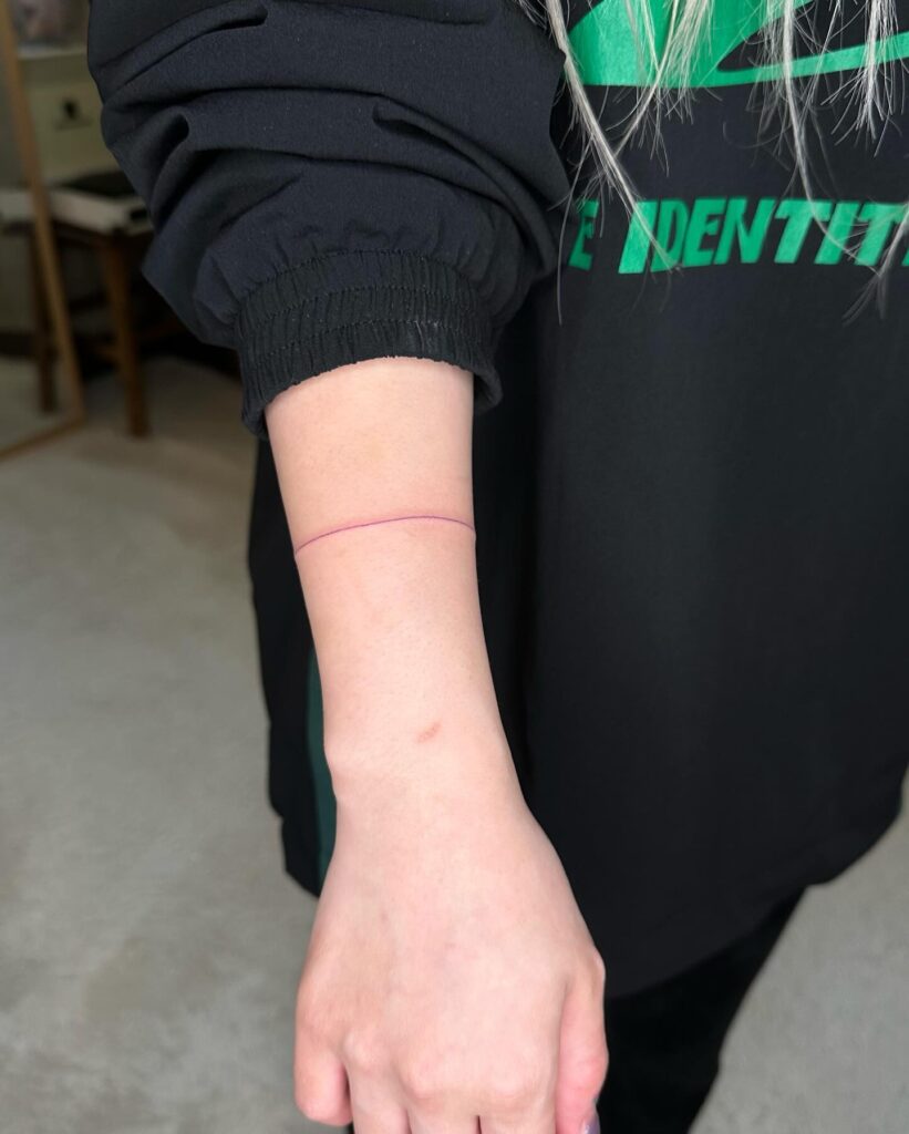 Thin Line Bracelet Tattoo on the Forearm: Graceful Adornment