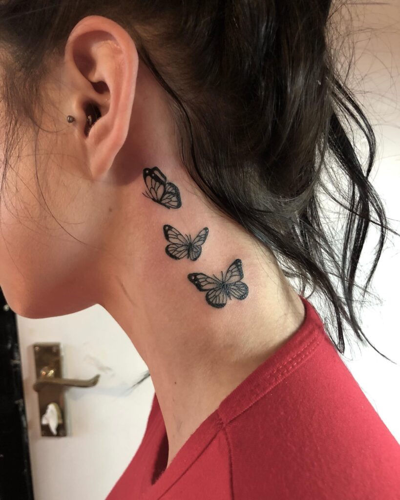 Three butterflies in flight graceful ink behind the ear for females