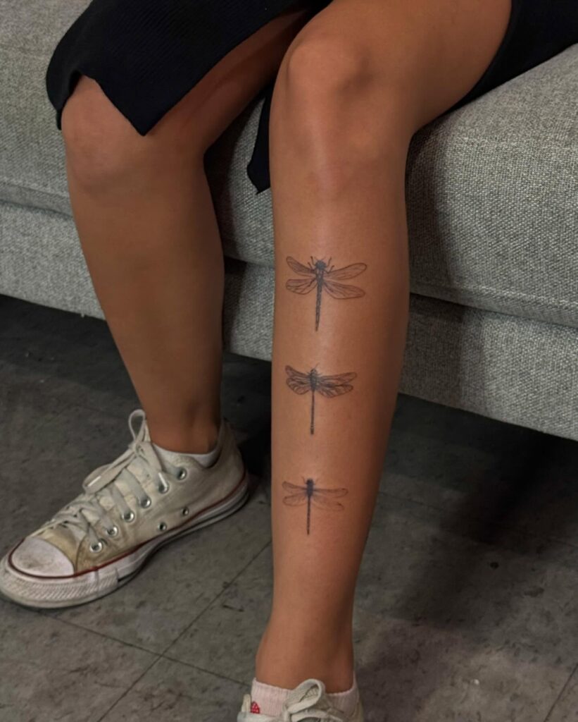 Three Dragonflies Leg Tattoo Representing Transformation and Movement