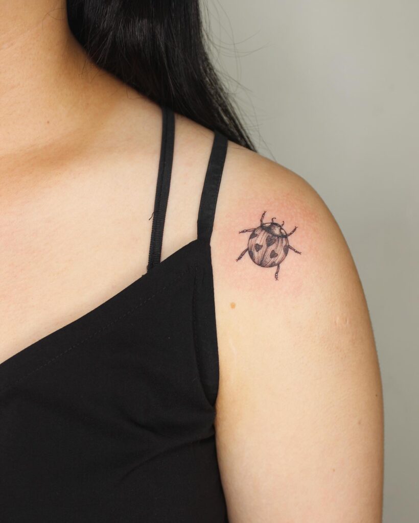 Timeless elegance classy ladybug upper arm tattoo for females