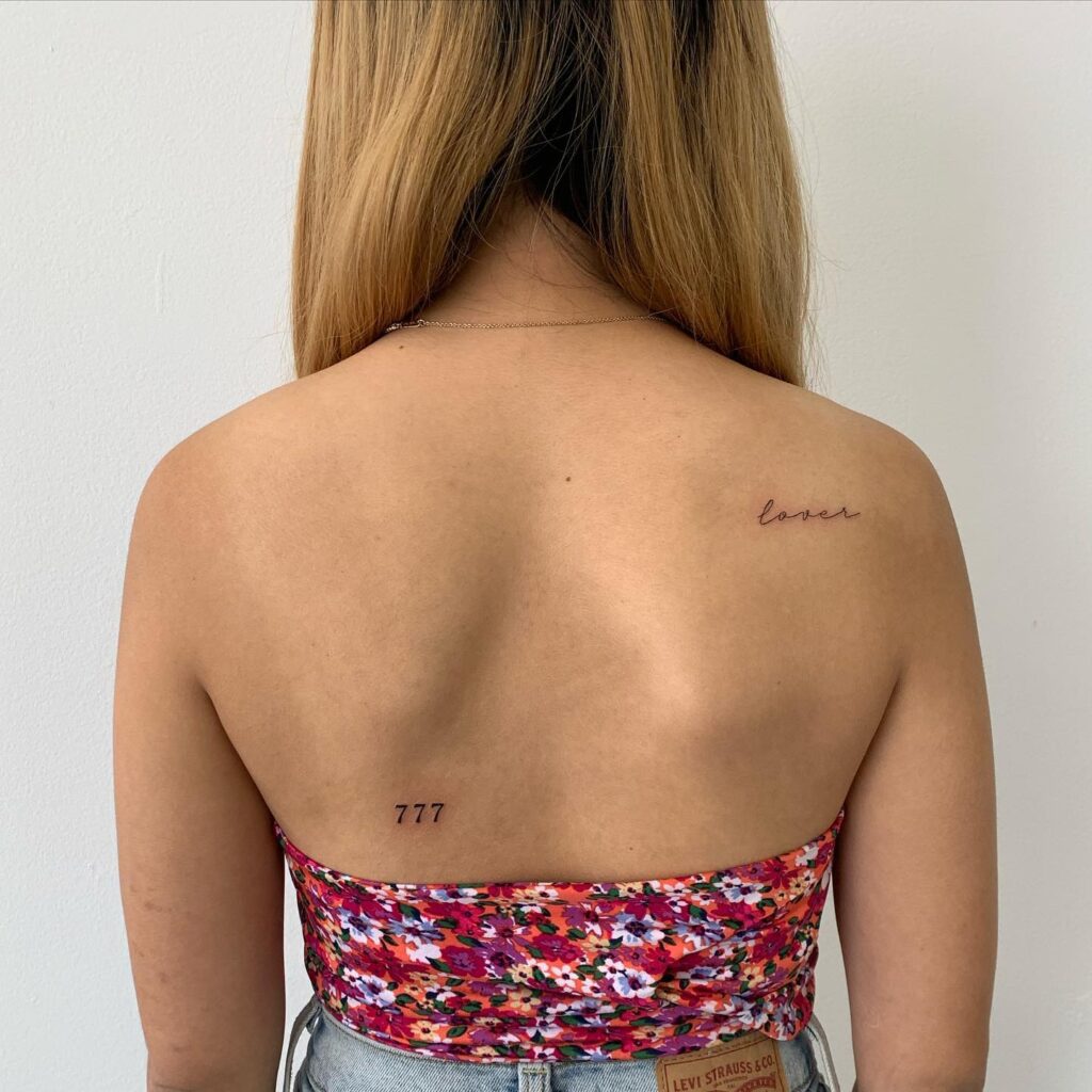 Tiny 777 tattoo design adorning the lower and mid back adding delicate charm to the skin back beauty 