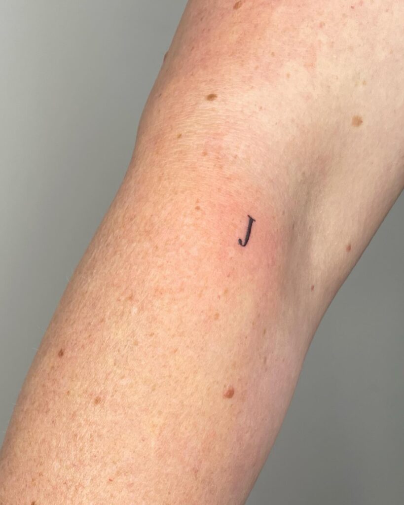 Tiny 'J' Letter Tattoo on the Inner Elbow: Personal Mark