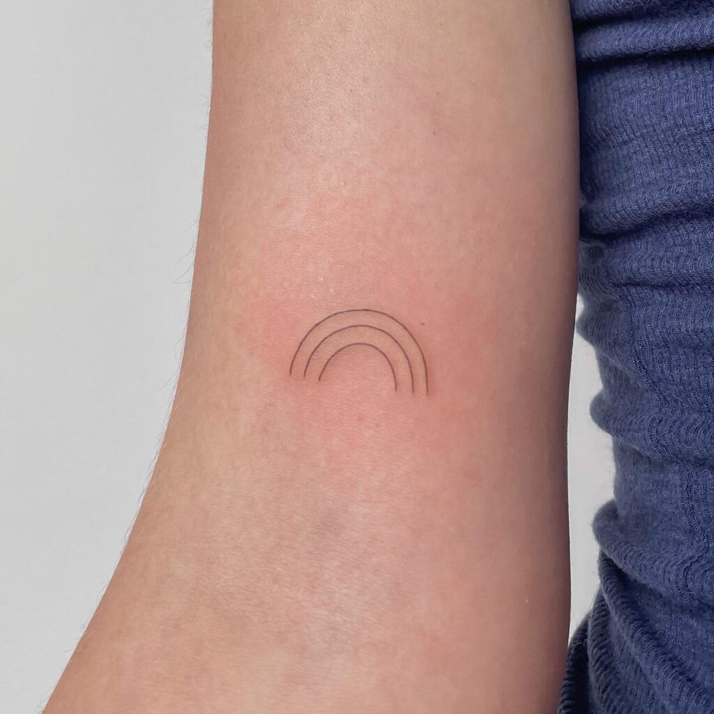 Tiny black and white rainbow above the elbow: subtle spectrum in three lines