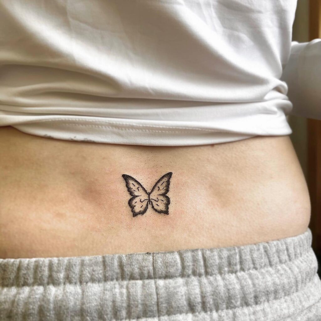 Tiny Butterfly Tattoo on the Lower Back: Fluttering Elegance