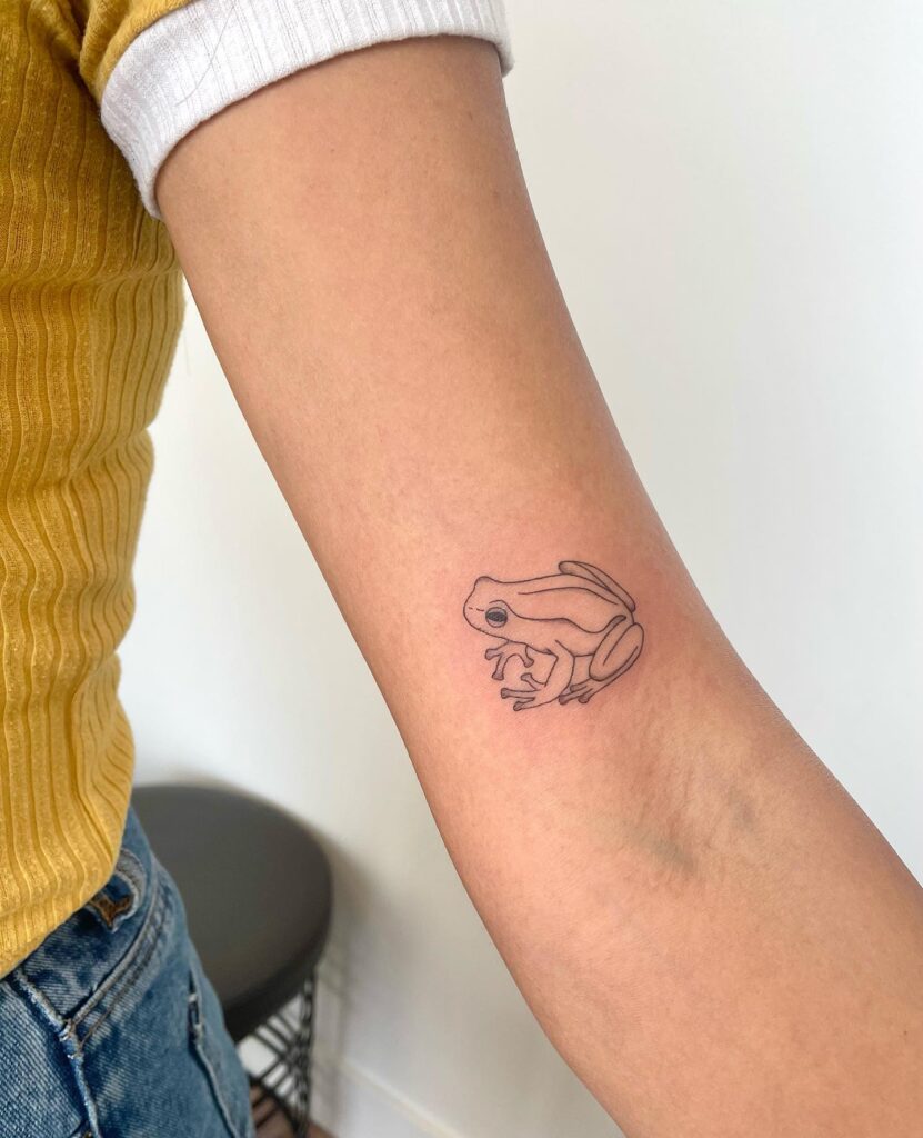 Tiny Frog Tattoo on the Above the Elbow: Amphibian Whimsy