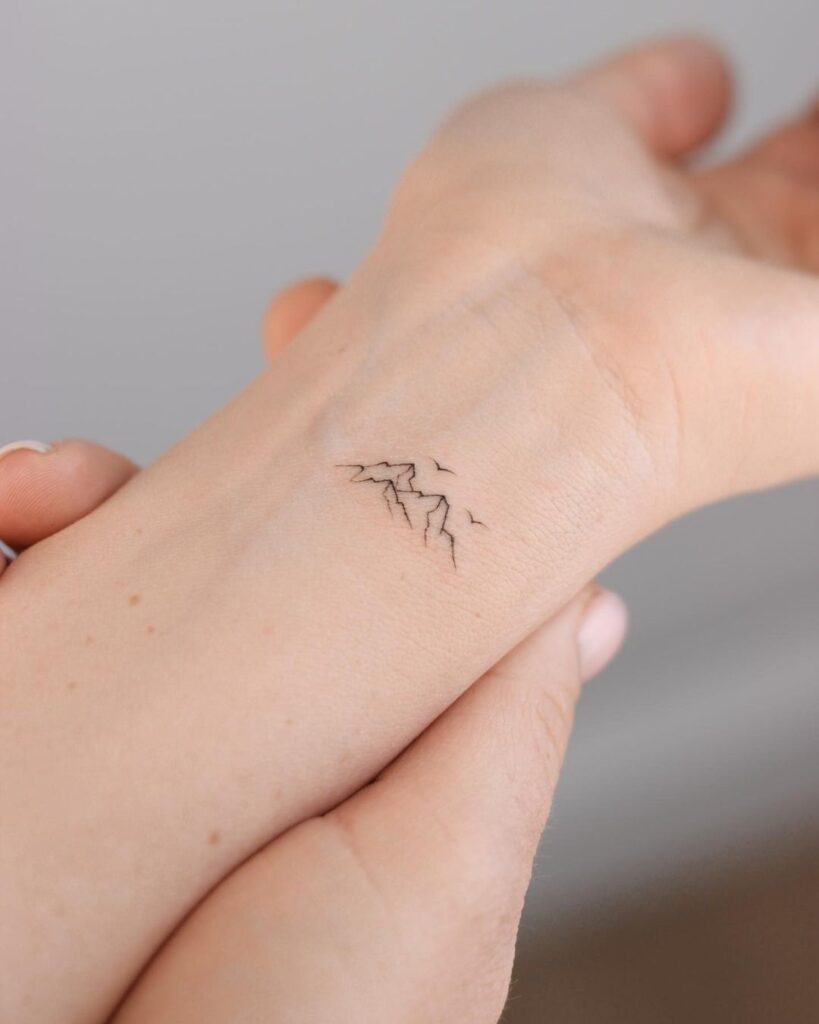 Tiny mountains tattoo on the wrist wrist peaks
