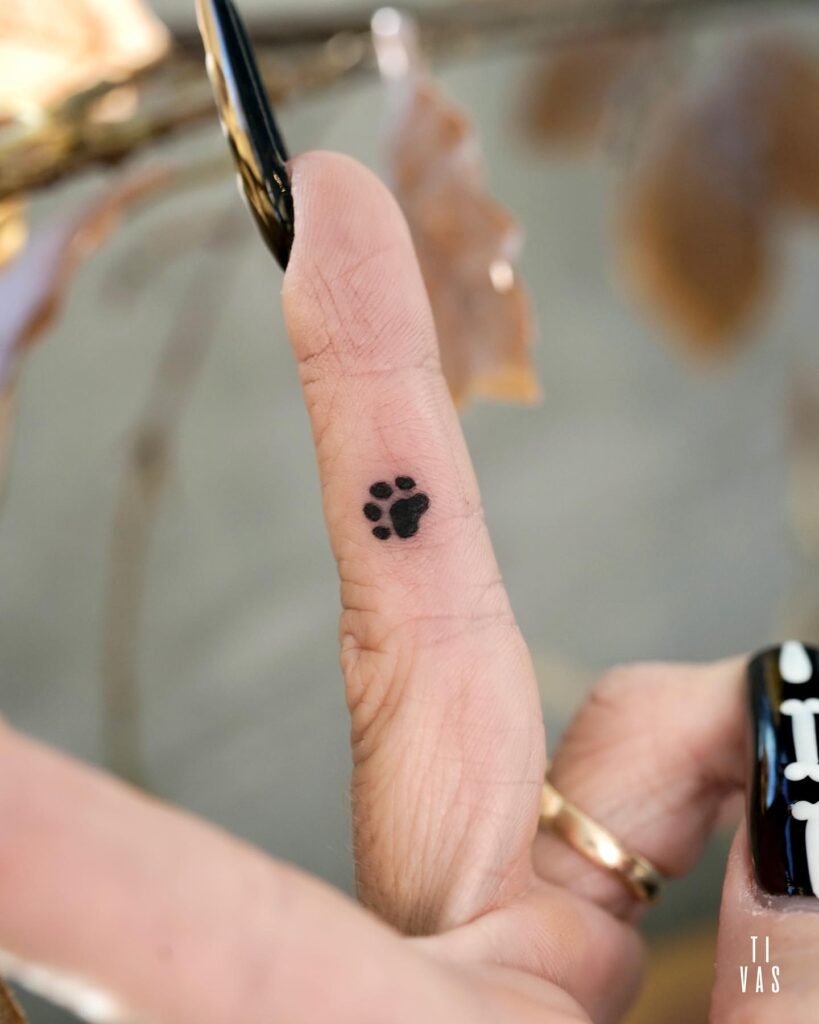 Tiny Paw Print Tattoo on the Side for a Subtle Statement: Middle Finger Minis