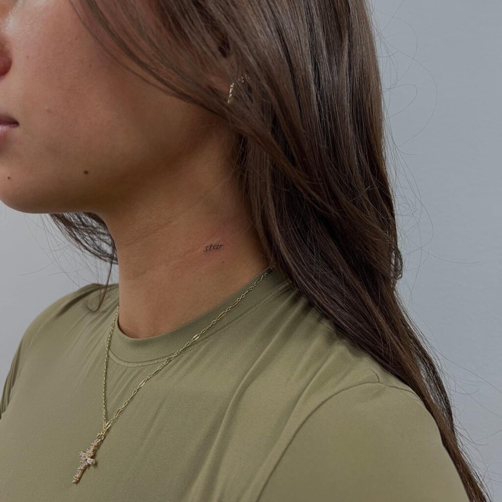 Tiny 'star' word lettering tattoo on the side neck, an ethereal fineline design: Stellar whisper