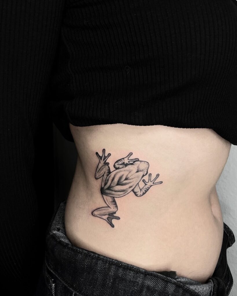 Top View Frog Black and Grey Shaded Tattoo on the Rib: Leap into Nature