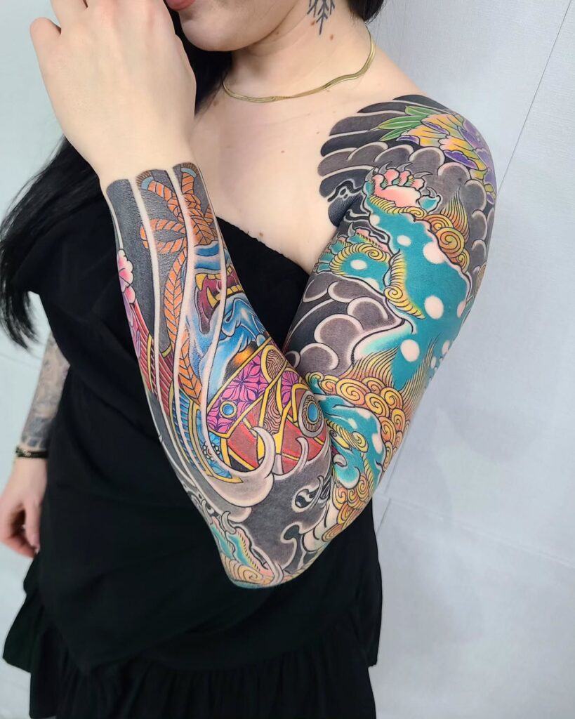 Traditional Japanese tattoo sleeve featuring waves, mythical creatures, and bold colors for girls
