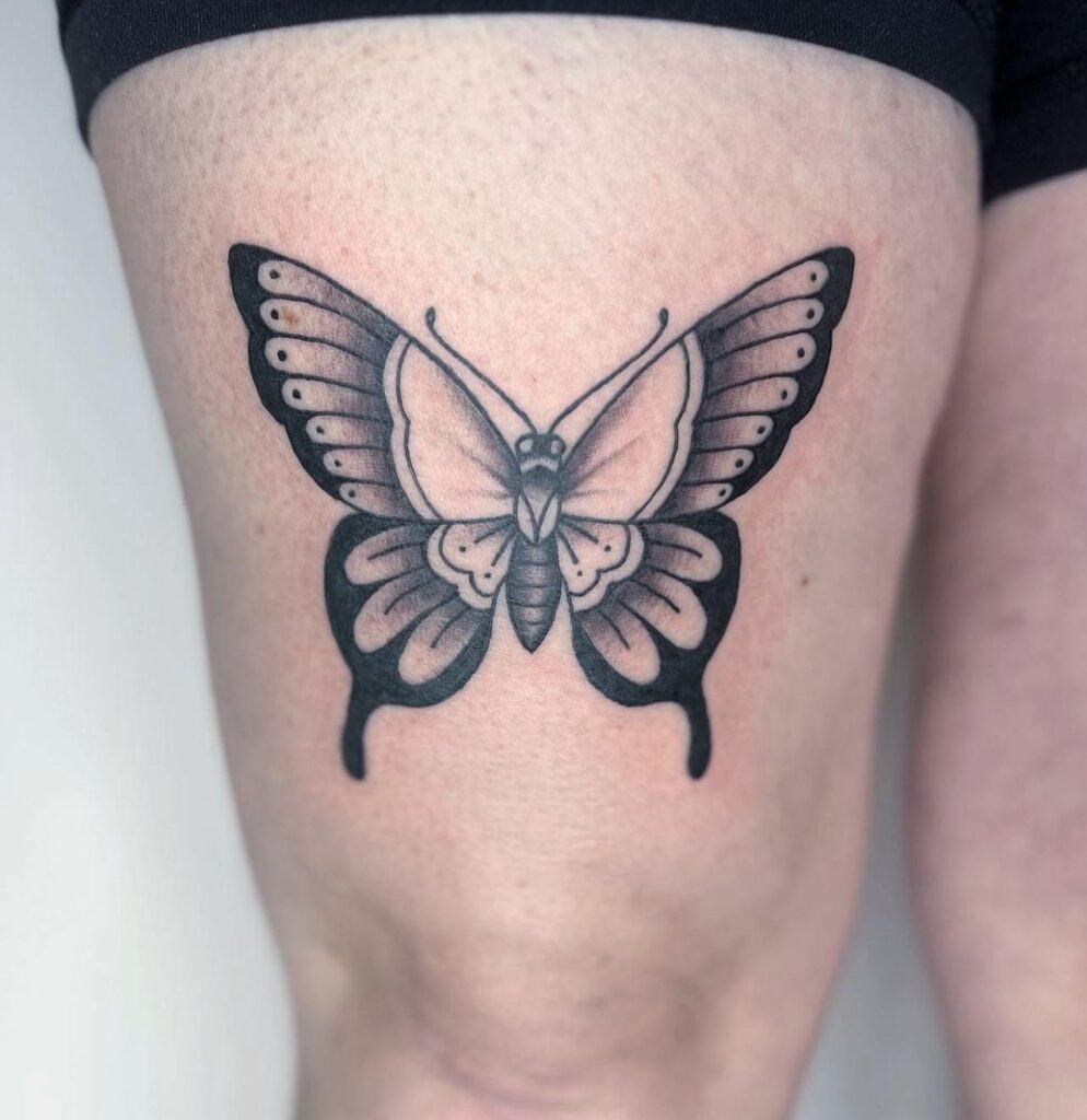 Traditional butterfly tattoo on thigh classic elegance