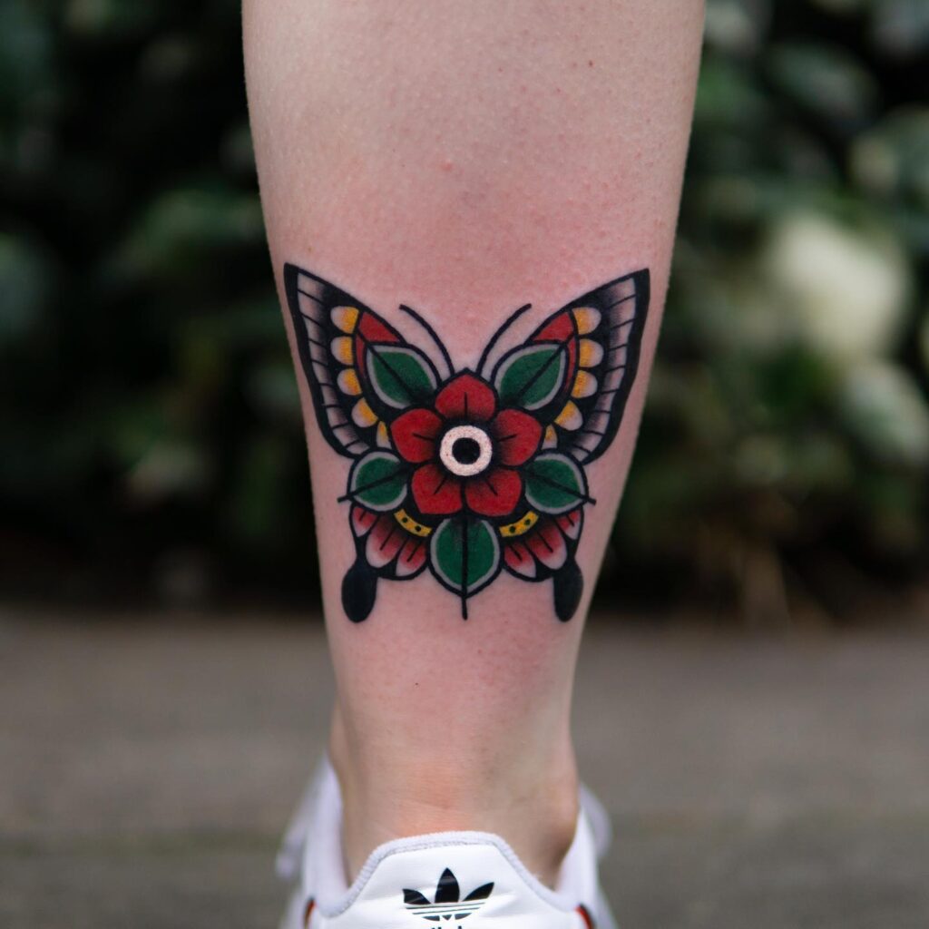 Traditional Colorful Flowerfly Tattoo on the Calf for a Vibrant Touch: Floral Flight 
