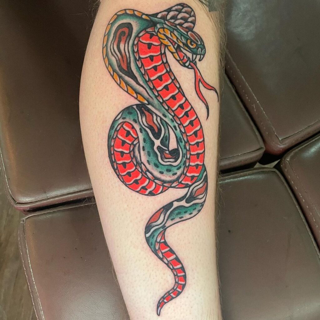Traditional pattern cobra tattoo new school cobra fight on side of calf