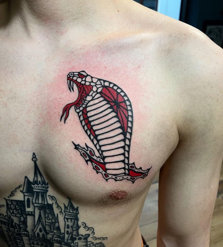 Traditional tattoo of cobra’s head mens black and red chest ink