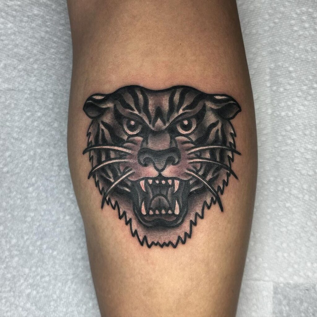 Traditional tiger face tattoo bold blackwork calf art