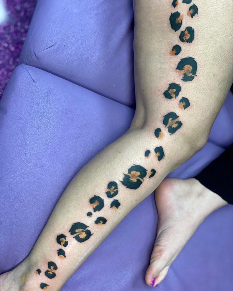 Trail of Confidence: Leopard Paw Print Tattoo from Thigh to Leg