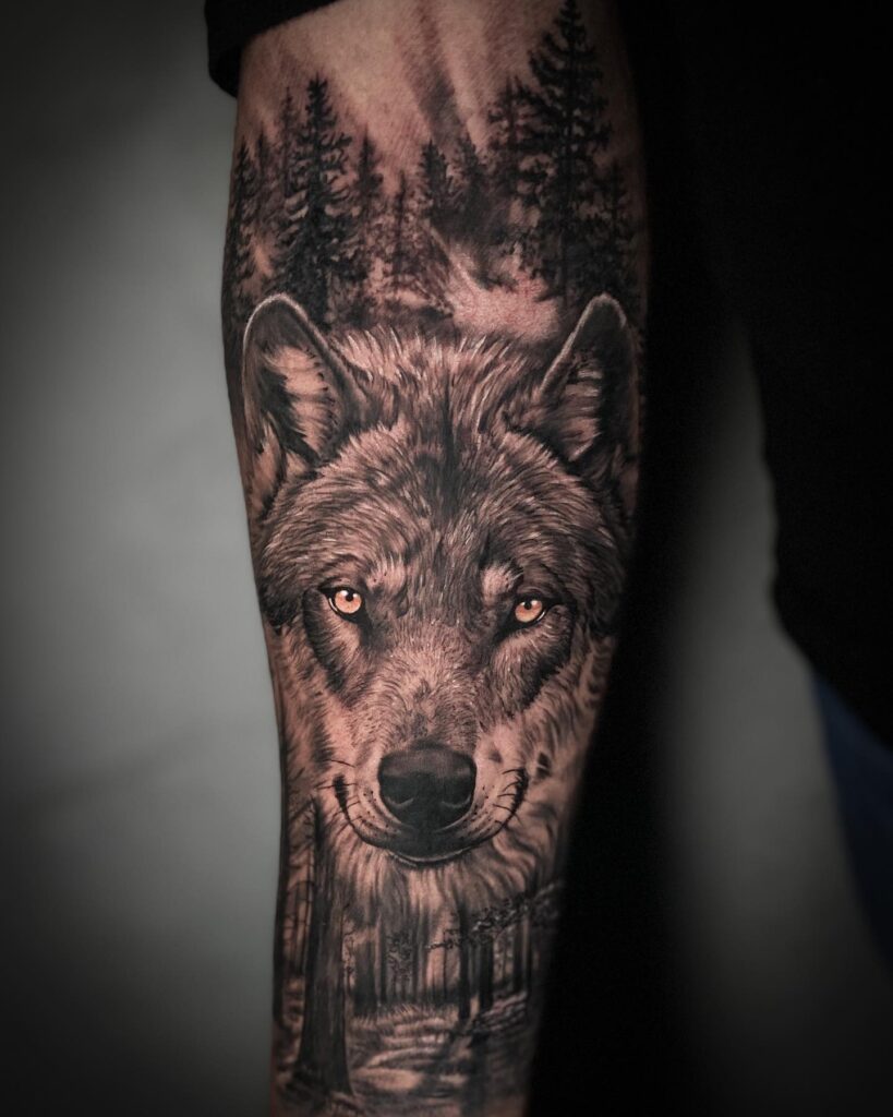 Tree-themed forearm tattoo for males wolf in the forest