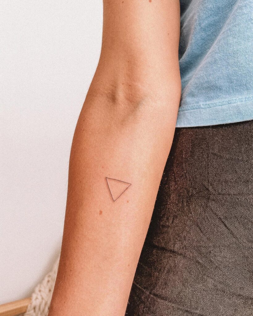 Triangle shape tattoo on the forearm, very thin lines for a minimalist touch: geometric whispers