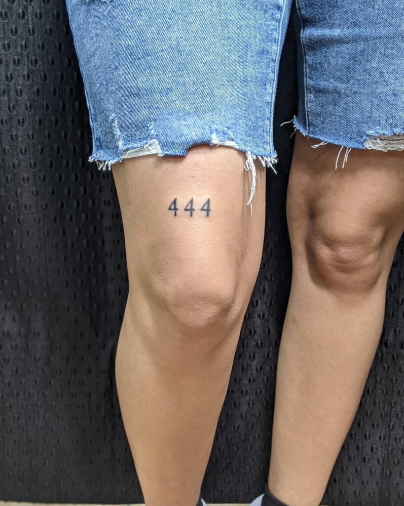 Triple 4 Tattoo Above the Knee: Artistic Design for Men
