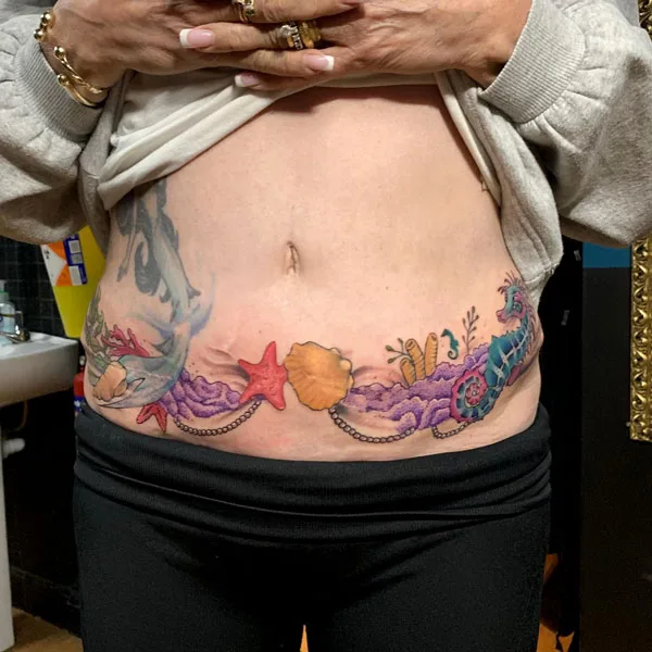 Tummy tuck scar tattoo 11