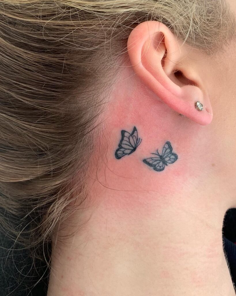 Two butterflies flying together tattoo behind the ear girl synchronized beauty