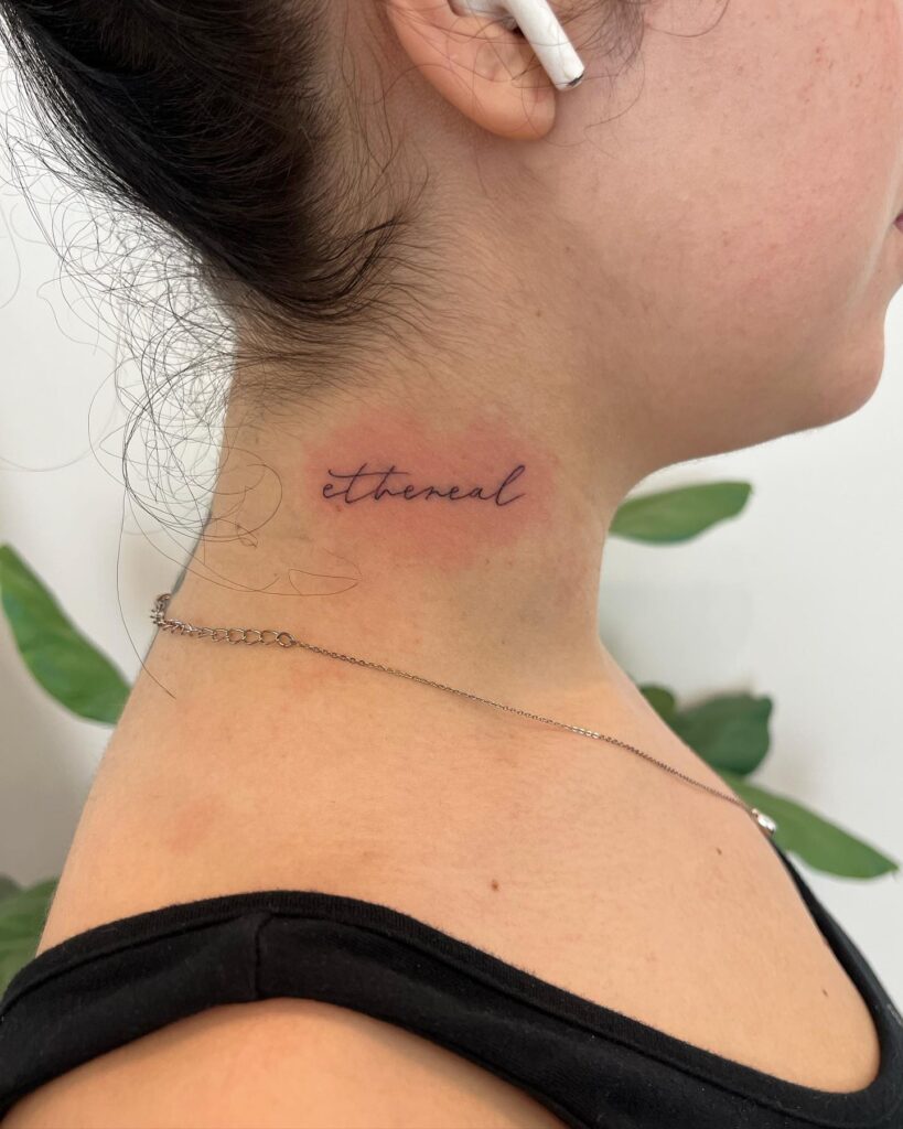 Ultra-thin script lettering tattoo on the side neck for a subtle flourish "ethereal" essence