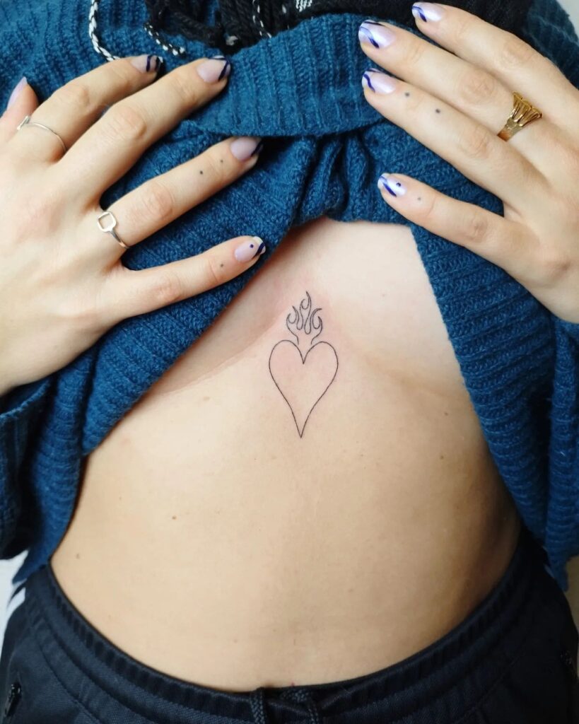 Under breast outline heart and flame tattoo for female sensual and unique expression
