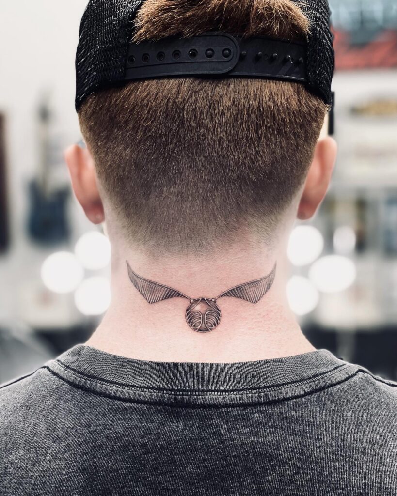 Understated elegance back neck golden snitch tattoo for guys