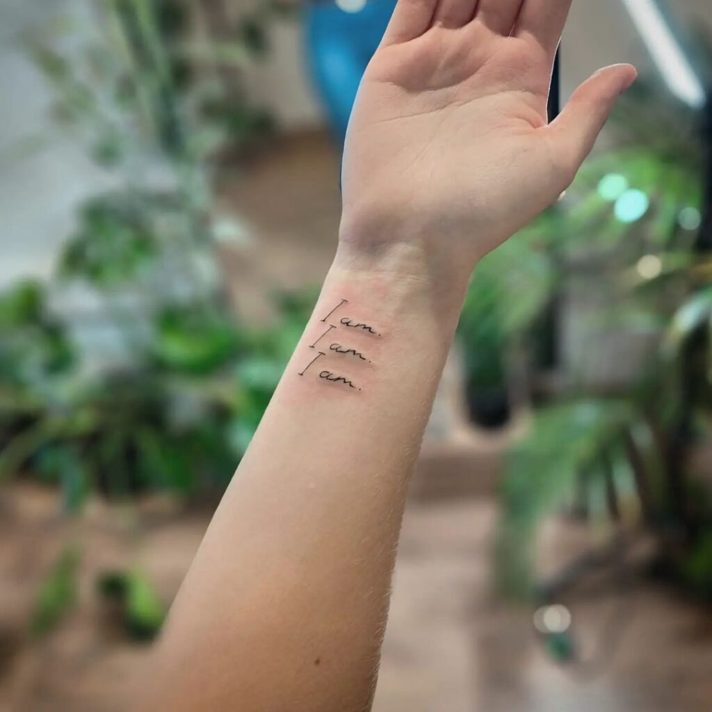Unique I am I am I am handwritten font tattoo on inner wrist