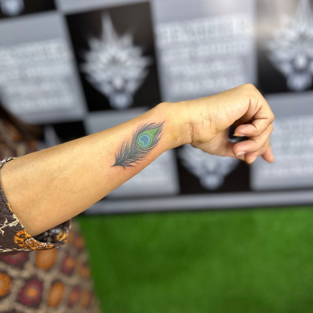 Unique Small Peacock Feather Tattoo on Wrist Delicate and Personalized