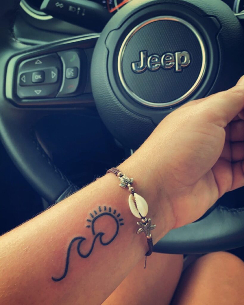 Unique Sun and Wave Tattoo on Forearm for Girls image