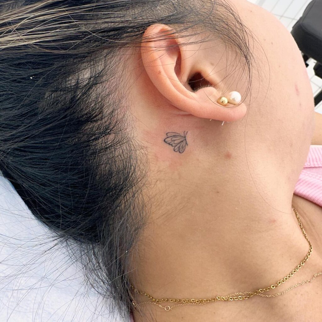 Unique flying butterfly tattoo behind ear small an emblem of individuality