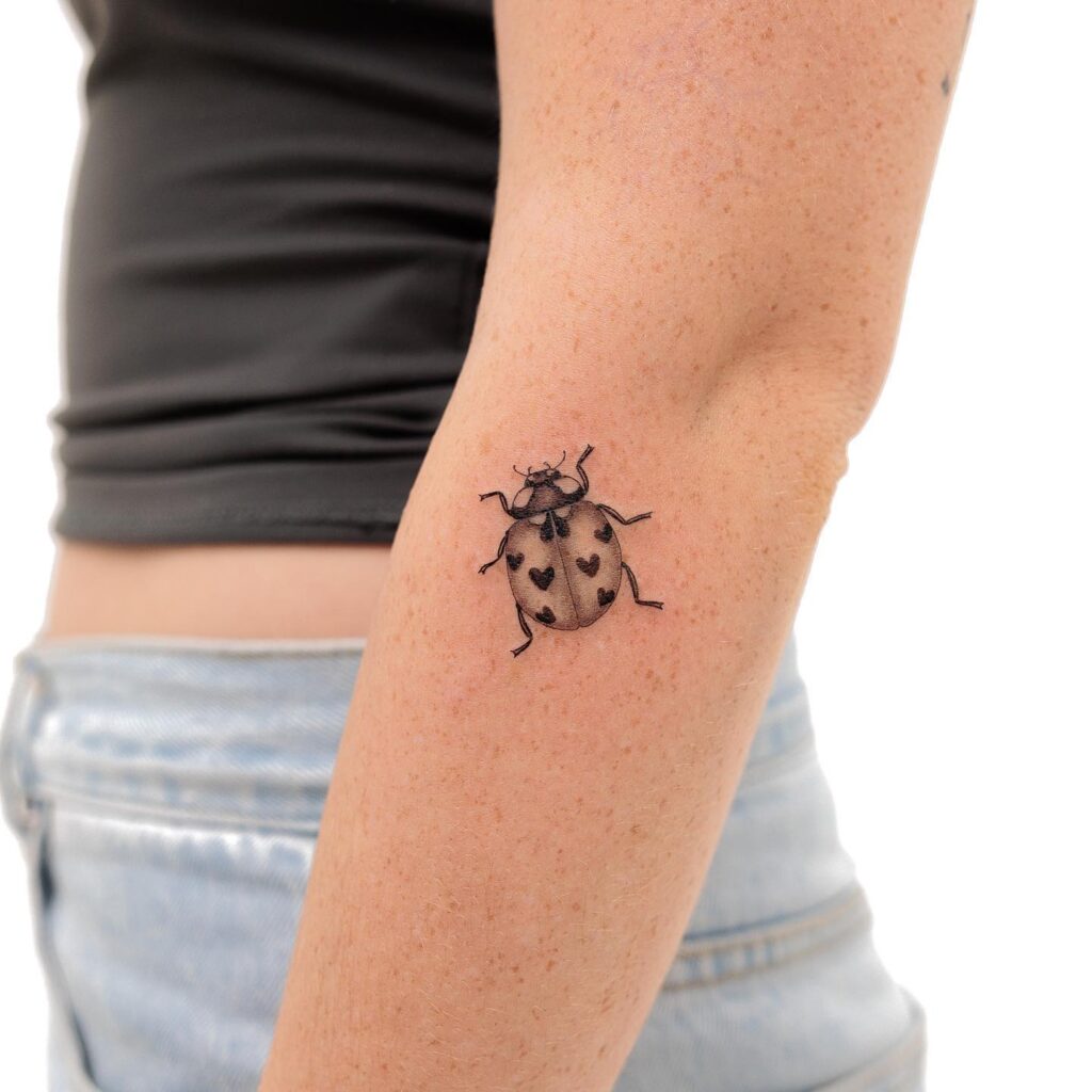 Unique ladybug illustration below the inner elbow elegance