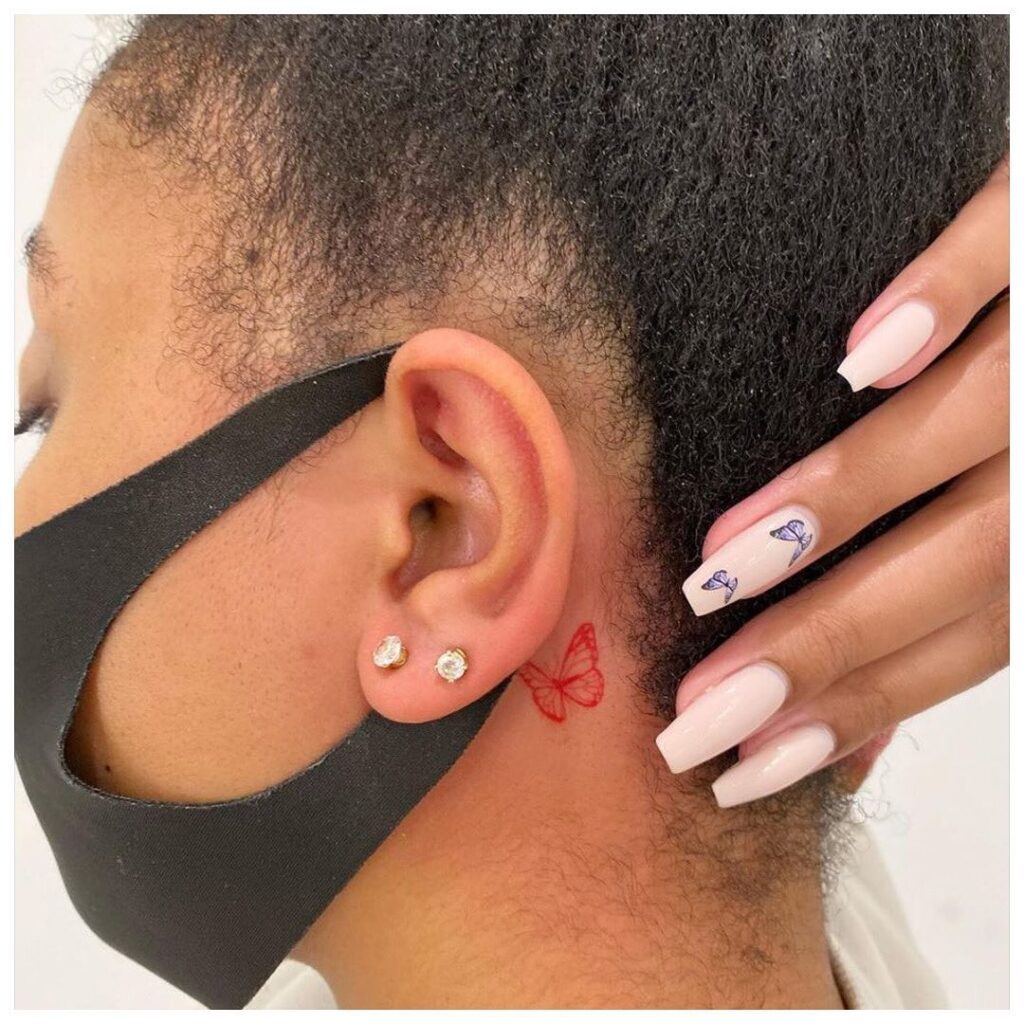 Unique red outline a minimal butterfly tattoo behind the ear
