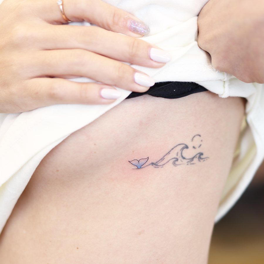 Unique sun and wave tattoo on the breast area image